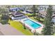 Aerial view of a community pool with lounge chairs surrounded by grass and trees at 900 Avenue Z Se # A3, Winter Haven, FL 33880