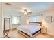 Bright bedroom features a ceiling fan, light hardwood flooring, and a comfortable king-size bed at 919 Avenue S Se, Winter Haven, FL 33880