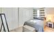 Comfortable bedroom featuring a gray bed, a mirror, a window and a dark end table with lamp at 919 Avenue S Se, Winter Haven, FL 33880