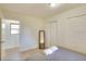 Simple bedroom featuring a gray bed with two towels, a window, a mirror and closet space at 919 Avenue S Se, Winter Haven, FL 33880