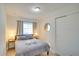 Cozy bedroom with a comfortable bed, window with curtain, bedside tables and lamps, and closet at 919 Avenue S Se, Winter Haven, FL 33880
