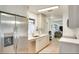 Contemporary kitchen with stainless steel refrigerator, white cabinetry, and ample counter space at 919 Avenue S Se, Winter Haven, FL 33880