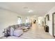Bright living room features an open layout, hardwood floors, comfortable seating, and backyard views at 919 Avenue S Se, Winter Haven, FL 33880