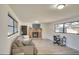 Comfortable living room featuring large windows for natural light, cozy sofa, and brick fireplace at 919 Avenue S Se, Winter Haven, FL 33880