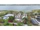 An aerial view shows the house, pool, neighboring buildings, and lake in the background at 926 S Lakeshore Blvd, Lake Wales, FL 33853