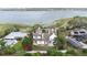 An aerial shot of the house situated amongst lush greenery, with a lake in the backdrop at 926 S Lakeshore Blvd, Lake Wales, FL 33853