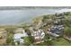 Aerial view of a house near a lake and roads surrounded by trees and neighboring houses at 926 S Lakeshore Blvd, Lake Wales, FL 33853