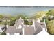 Aerial view of the home showing the roof and dormer windows with a lake in the distance at 926 S Lakeshore Blvd, Lake Wales, FL 33853