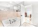 Bathroom boasts soaking tub with travertine tile surround at 926 S Lakeshore Blvd, Lake Wales, FL 33853