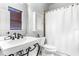 Classic bathroom with a decorative sink, toilet, medicine cabinet, and shower with curtain at 926 S Lakeshore Blvd, Lake Wales, FL 33853