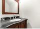 Elegant powder room featuring a dark granite countertop and decorative vanity at 926 S Lakeshore Blvd, Lake Wales, FL 33853