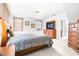 Bright bedroom with neutral paint, tv, and a bed with neutral bedding at 926 S Lakeshore Blvd, Lake Wales, FL 33853