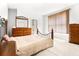 Bedroom with dresser, mirror, and a wrought iron bed frame at 926 S Lakeshore Blvd, Lake Wales, FL 33853