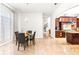 Well-lit dining area leading to an open-concept kitchen and staircase at 926 S Lakeshore Blvd, Lake Wales, FL 33853
