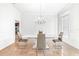Bright dining room with modern chandelier, table, chairs, and neutral color palette at 926 S Lakeshore Blvd, Lake Wales, FL 33853