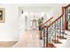 Bright foyer with glossy tile floors and decorative stairway at 926 S Lakeshore Blvd, Lake Wales, FL 33853