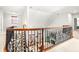 View of staircase with rod iron railing overlooking the sitting area with fireplace at 926 S Lakeshore Blvd, Lake Wales, FL 33853