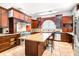 Gourmet kitchen with custom wood cabinetry, granite counters, and stainless steel appliances at 926 S Lakeshore Blvd, Lake Wales, FL 33853