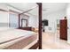 Bright main bedroom boasts a canopy bed and a large TV at 926 S Lakeshore Blvd, Lake Wales, FL 33853