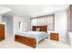 Spacious main bedroom featuring a wooden bed frame, bedside table, and carpeted flooring at 926 S Lakeshore Blvd, Lake Wales, FL 33853