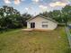 Exterior view of the home featuring a spacious backyard with a patio and lush greenery at 991 Old Scenic Hwy, Lake Wales, FL 33853