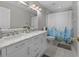 Bathroom with double sink vanity and a shower tub combination with floral curtain at 991 Old Scenic Hwy, Lake Wales, FL 33853