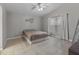 Bright bedroom with neutral walls, tile floors, ceiling fan, and large window at 991 Old Scenic Hwy, Lake Wales, FL 33853