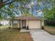Charming single-story home with a well-maintained lawn and attached two-car garage at 991 Old Scenic Hwy, Lake Wales, FL 33853