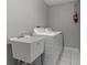 Functional laundry room with a utility sink, washer, and dryer at 991 Old Scenic Hwy, Lake Wales, FL 33853