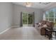 Inviting living room with tile floors, comfortable seating, and sliding glass doors to the patio at 991 Old Scenic Hwy, Lake Wales, FL 33853