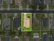 Aerial top-down view showcases the home's roof, driveway, and surrounding landscaped yard at 10234 Lenox St, Clermont, FL 34711