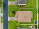 Overhead aerial view of a home with well-manicured lawn, brick driveway, and a charming two-story layout at 10234 Lenox St, Clermont, FL 34711