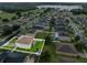 Aerial view of a charming two-story home with a well-manicured lawn and fence in a planned community at 10234 Lenox St, Clermont, FL 34711
