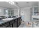 Bathroom featuring double sinks, bath tub, stand up shower, and tile flooring at 10234 Lenox St, Clermont, FL 34711