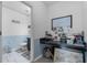 Bathroom with modern gray vanity and convenient under-counter storage at 10234 Lenox St, Clermont, FL 34711