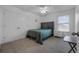 Bedroom with a queen bed, ceiling fan, carpeted floor, closet and a window at 10234 Lenox St, Clermont, FL 34711