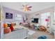 Bright, cozy bedroom with white furniture, plushy rug, and a decorative ceiling fan at 10234 Lenox St, Clermont, FL 34711