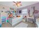 Bedroom features decor, carpet floor, ceiling fan, and natural light at 10234 Lenox St, Clermont, FL 34711