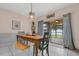 Bright dining area featuring a rustic dining table with seating for a Gathering at 10234 Lenox St, Clermont, FL 34711