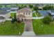 Charming two-story home features a brick driveway, manicured lawn, and welcoming front porch at 10234 Lenox St, Clermont, FL 34711
