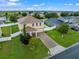 Charming two-story home features a brick driveway, manicured lawn, and welcoming front porch at 10234 Lenox St, Clermont, FL 34711