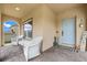 Inviting front porch with brick floors, ample seating, and a cheerful blue front door at 10234 Lenox St, Clermont, FL 34711