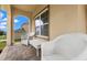Charming front porch with brick floors, white furniture and detailed columns creating an inviting space at 10234 Lenox St, Clermont, FL 34711