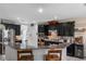 The kitchen features stainless steel appliances, granite countertops, and dark wood cabinetry at 10234 Lenox St, Clermont, FL 34711
