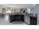 The kitchen features stainless steel appliances, granite countertops, and dark wood cabinetry at 10234 Lenox St, Clermont, FL 34711