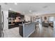 Well-appointed kitchen with dark cabinetry, stainless steel appliances, and a breakfast bar at 10234 Lenox St, Clermont, FL 34711