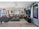 Comfortable living room with a sectional, patterned ottoman, and neutral area rug at 10234 Lenox St, Clermont, FL 34711