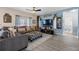 Comfortable living room with gray sectional, stylish ottoman, and neutral color palette at 10234 Lenox St, Clermont, FL 34711
