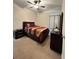 Bedroom with ceiling fan, and dresser with flower, creating a cozy and inviting space at 1056 Naes Ln, Lake Wales, FL 33853