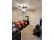 Cozy bedroom featuring a ceiling fan, dresser with mirror, and comfortable bed at 1056 Naes Ln, Lake Wales, FL 33853